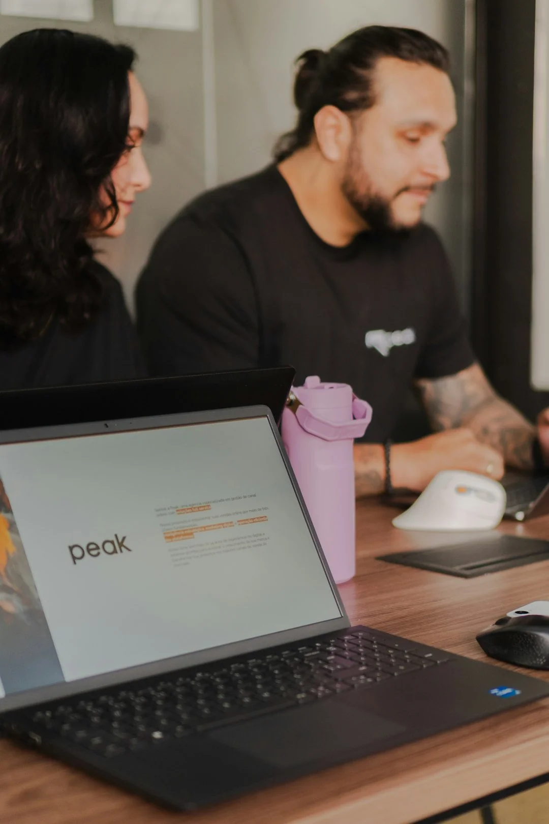 Three diverse people discussing packaging design with color samples, ideal for small business marketing.